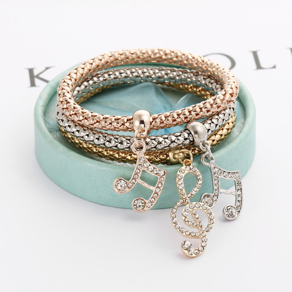 Fashion simple hollow carved three-color set music rhinestone bracelet